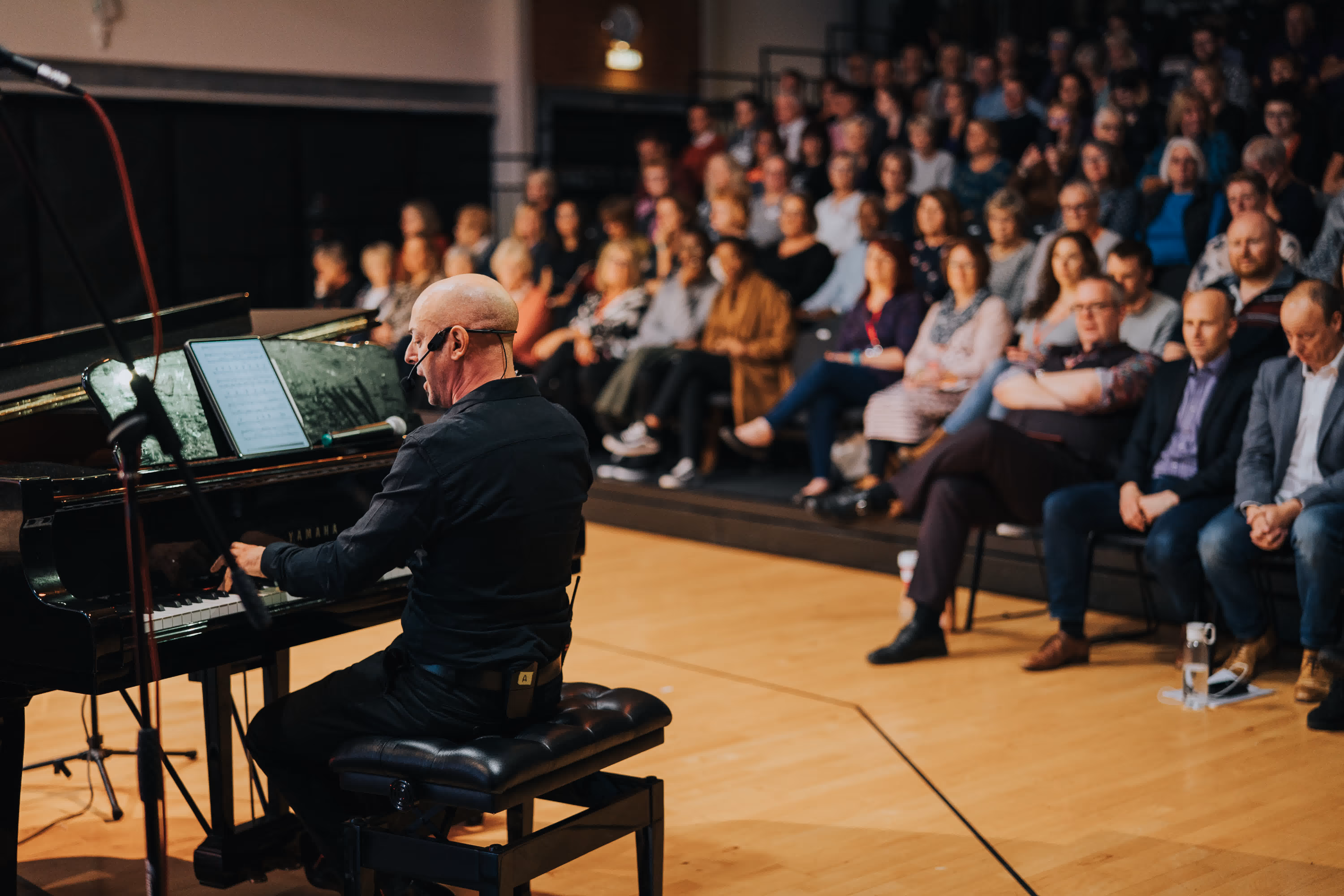 Russell leading singers through a choir workshop